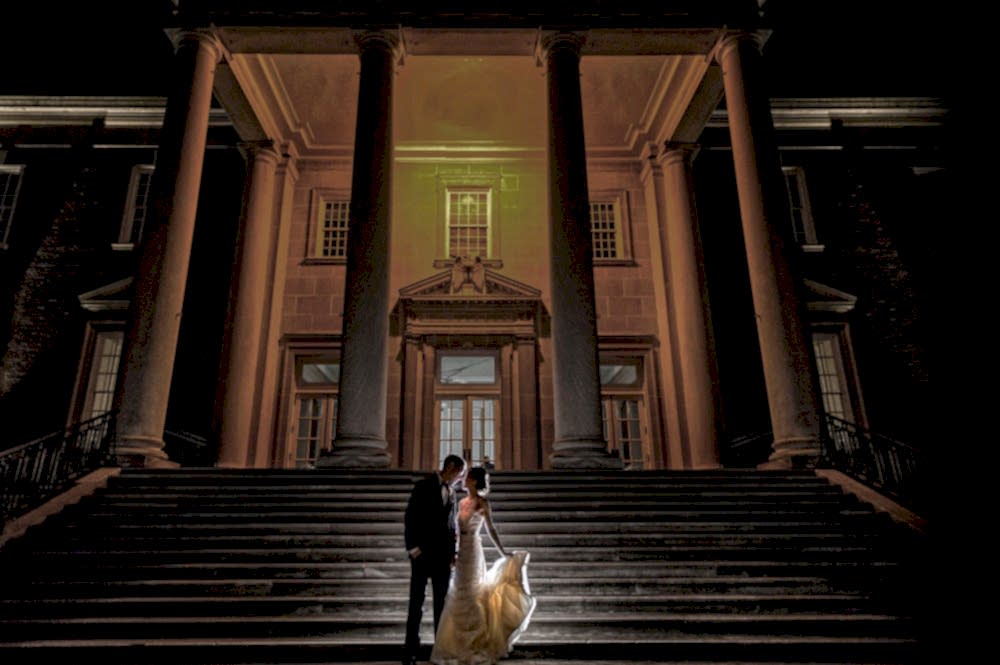 bride and groom night photo lit from behind in fron of the Chicago Historical Museum Wedding